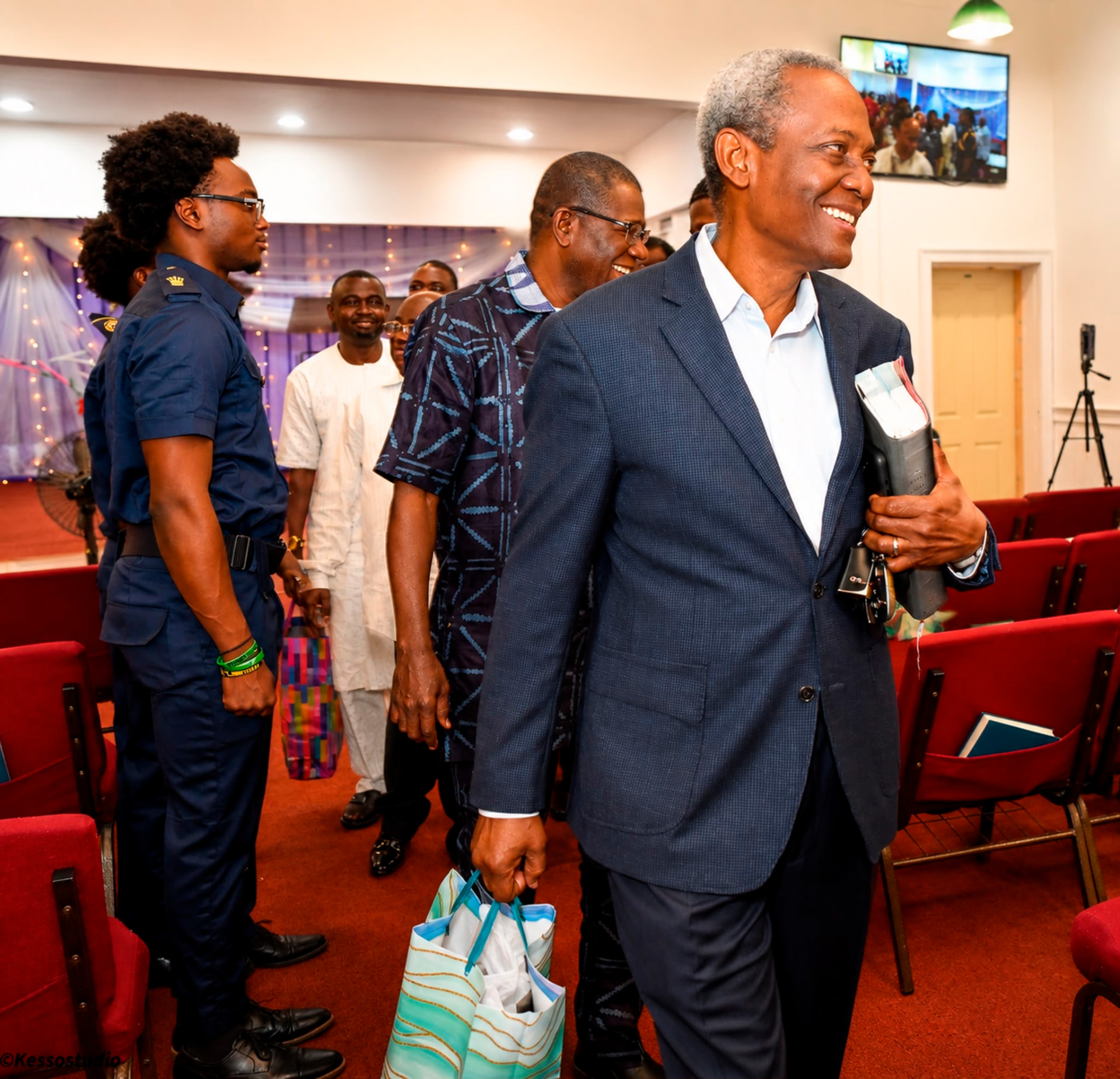 Men greeting one another as they arrive