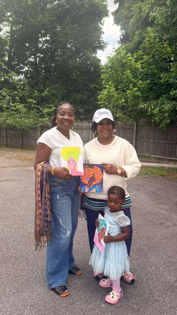 Two women and a little girl with their paintings