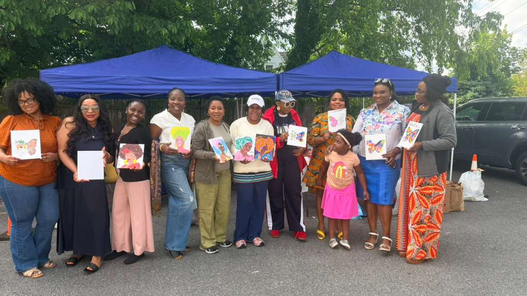 The whole paint and fellowship group with their artwork